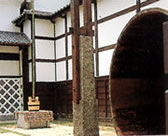 A well with a well bucket and a large wooden tub.